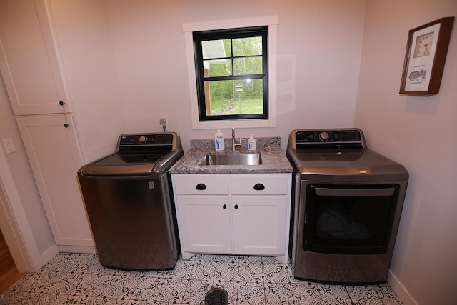 5004 W Rd, Silver Twp, MN 55767 - laundry room with cabinet space, baseboards, light tile patterned floors, and washer and clothes dryer