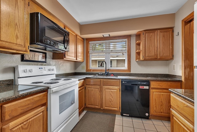2007 8th St N, Saint Cloud, MN 56303 - kitchen with black appliances, light tile patterned floors, brown cabinets, and dark stone counters