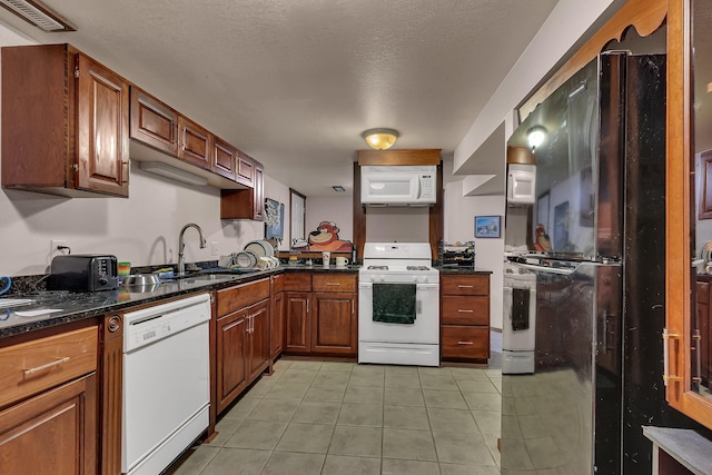 2007 8th St N, Saint Cloud, MN 56303 - kitchen with white appliances, light tile patterned floors, and brown cabinetry