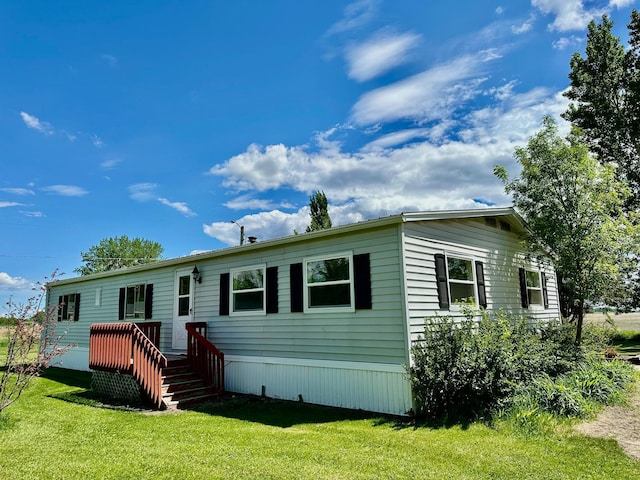 15373 Shawn St, Rocksbury Twp, MN 56701 - rear view of property with a lawn and a wooden deck