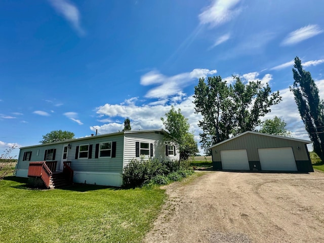 15373 Shawn St, Rocksbury Twp, MN 56701 - view of front of house with a detached garage, an outdoor structure, and a front lawn