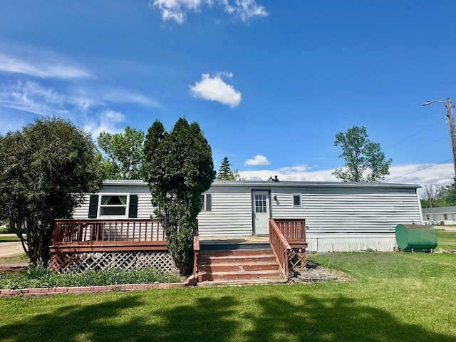15373 Shawn St, Rocksbury Twp, MN 56701 - rear view of property with oil tank, a wooden deck, and a yard