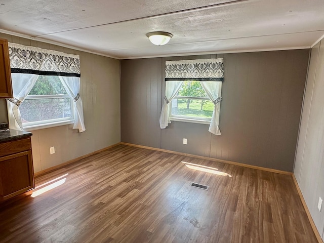 15373 Shawn St, Rocksbury Twp, MN 56701 - empty room featuring wood finished floors, baseboards, and crown molding