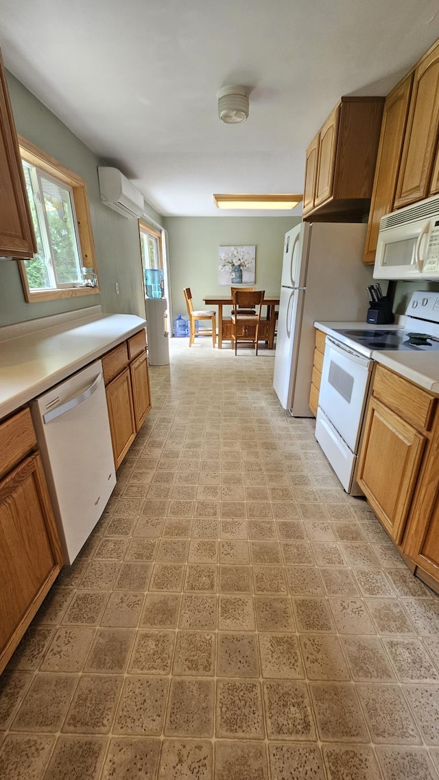 1309 Elm Ave N, Wheaton, MN 56296 - kitchen with white appliances, an AC wall unit, and light countertops