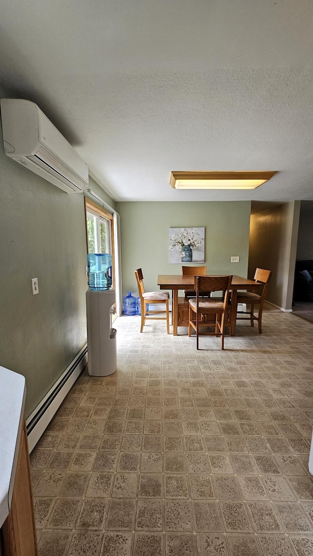 1309 Elm Ave N, Wheaton, MN 56296 - dining area with a baseboard heating unit, a wall mounted air conditioner, and a textured ceiling