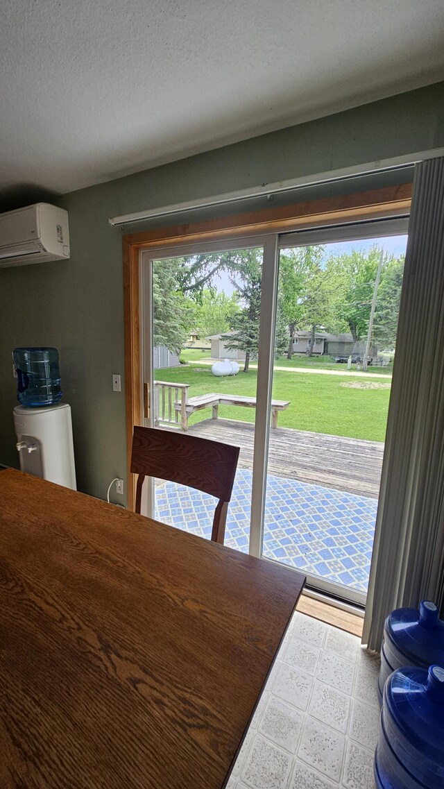 1309 Elm Ave N, Wheaton, MN 56296 - dining space with a wall mounted AC, tile patterned floors, and a textured ceiling