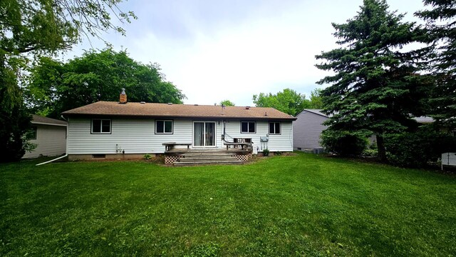 1309 Elm Ave N, Wheaton, MN 56296 - back of property with a lawn, a wooden deck, and a chimney