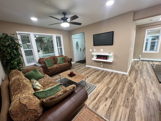 975 4th St E, Saint Paul, MN 55106 - living room with baseboards, a baseboard heating unit, wood finished floors, a ceiling fan, and recessed lighting