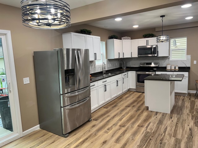 975 4th St E, Saint Paul, MN 55106 - kitchen with appliances with stainless steel finishes, tasteful backsplash, white cabinets, and recessed lighting