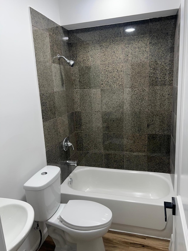 975 4th St E, Saint Paul, MN 55106 - bathroom with toilet, bathing tub / shower combination, wood finished floors, and a sink