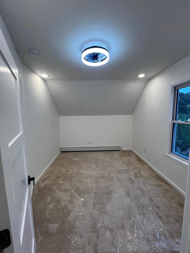 975 4th St E, Saint Paul, MN 55106 - bonus room with vaulted ceiling, carpet flooring, baseboards, and a baseboard heating unit