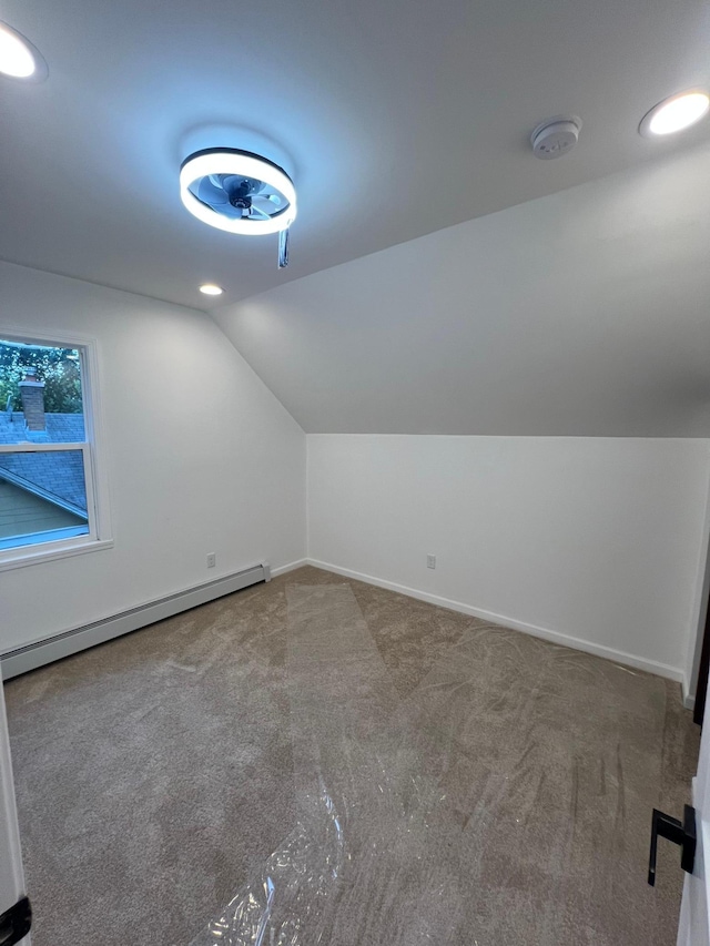 975 4th St E, Saint Paul, MN 55106 - additional living space with a baseboard heating unit, lofted ceiling, carpet floors, and baseboards