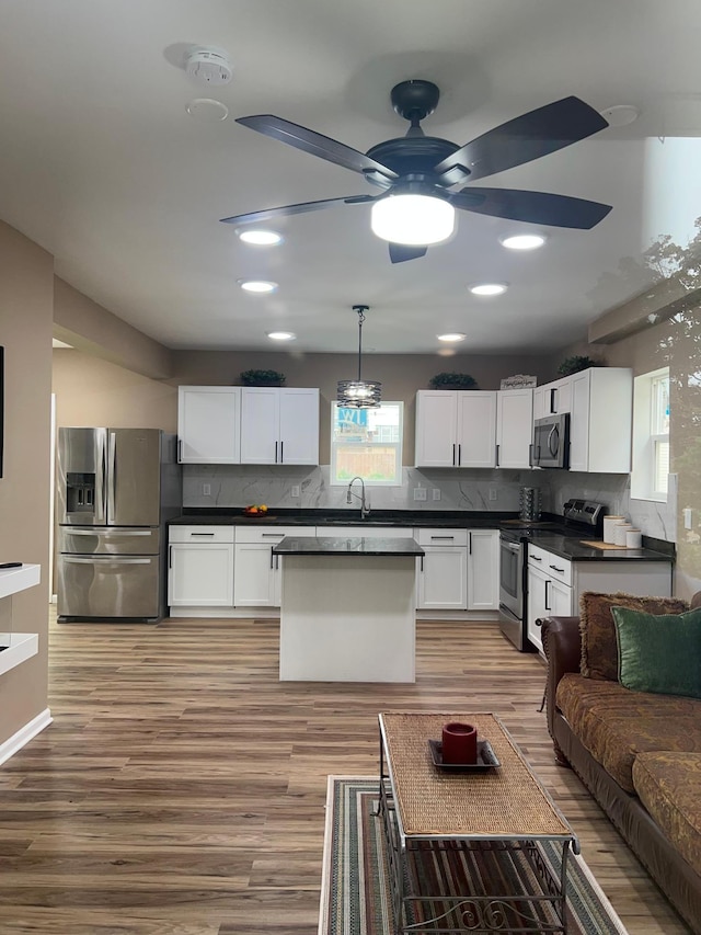 975 4th St E, Saint Paul, MN 55106 - kitchen with stainless steel appliances, dark countertops, healthy amount of natural light, and recessed lighting