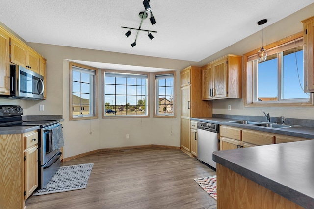 900 Isabella Ave, Clearwater, MN 55320 - kitchen featuring stainless steel appliances, dark countertops, plenty of natural light, a sink, and a textured ceiling