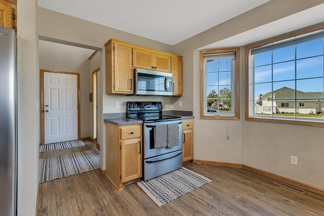 900 Isabella Ave, Clearwater, MN 55320 - kitchen featuring stainless steel appliances, dark wood finished floors, baseboards, and dark countertops