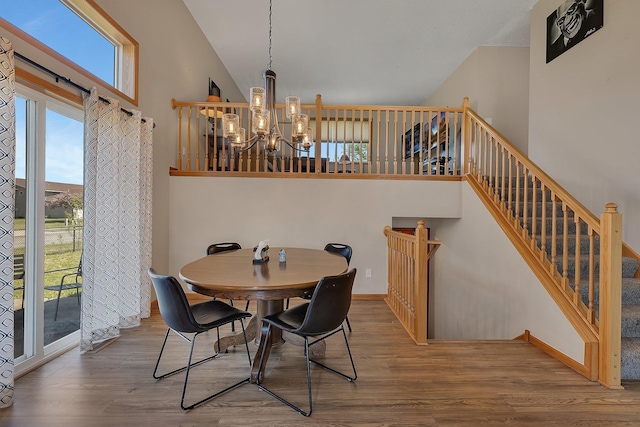 900 Isabella Ave, Clearwater, MN 55320 - dining room with a chandelier, wood finished floors, healthy amount of natural light, and a towering ceiling