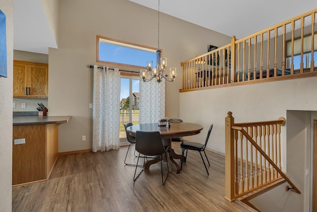 900 Isabella Ave, Clearwater, MN 55320 - dining space featuring high vaulted ceiling, wood finished floors, a chandelier, and baseboards