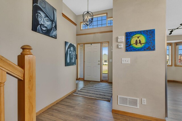 900 Isabella Ave, Clearwater, MN 55320 - foyer with wood finished floors, baseboards, and a chandelier