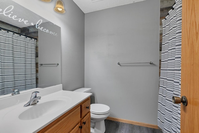 900 Isabella Ave, Clearwater, MN 55320 - full bathroom with wood finished floors, vanity, toilet, baseboards, and a shower with shower curtain