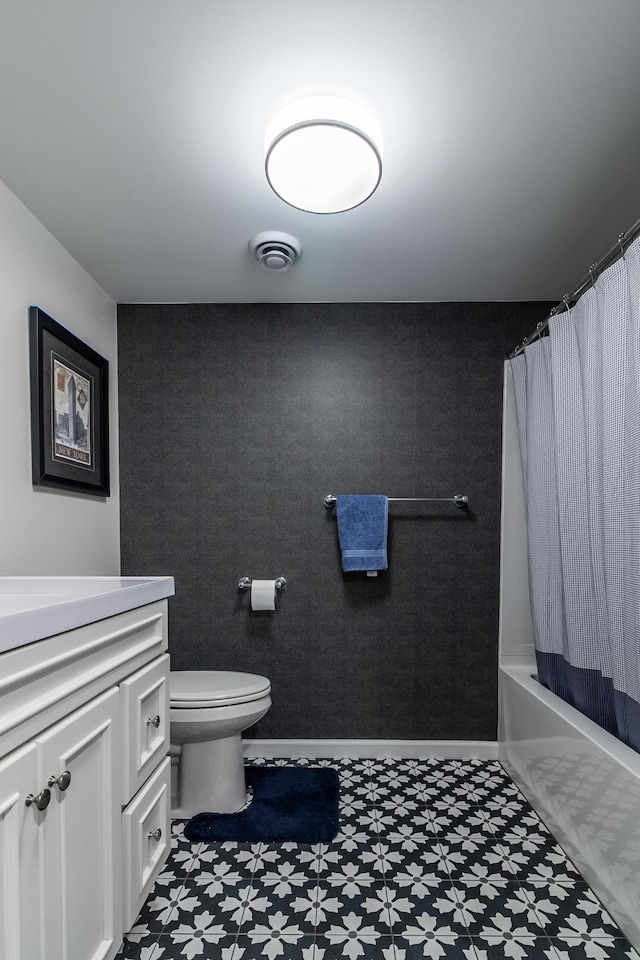 2105 7th Ave S, Saint Cloud, MN 56301 - bathroom featuring vanity, toilet, tile patterned floors, and shower / bath combo with shower curtain