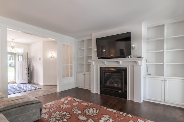 2105 7th Ave S, Saint Cloud, MN 56301 - living room with built in features, dark wood-style floors, a glass covered fireplace, and baseboards