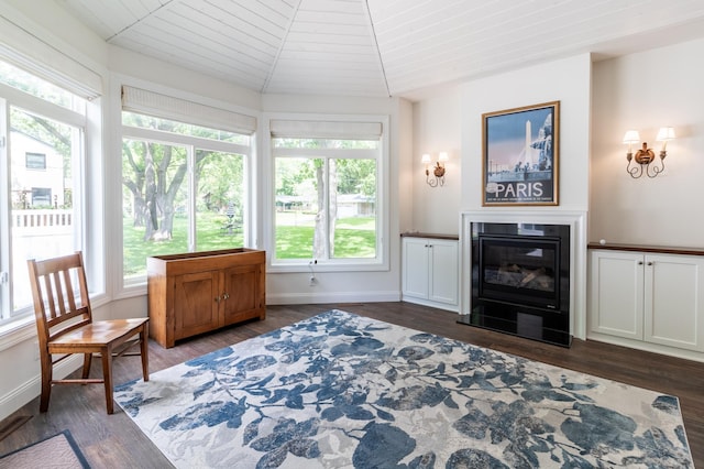 2105 7th Ave S, Saint Cloud, MN 56301 - living area with dark wood finished floors, lofted ceiling, baseboards, a glass covered fireplace, and wooden ceiling