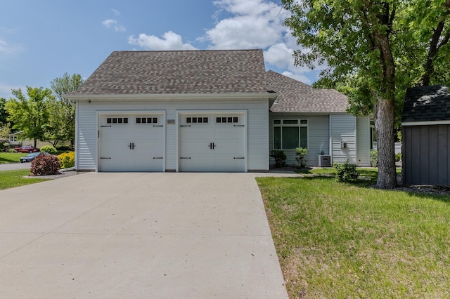 2105 7th Ave S, Saint Cloud, MN 56301 - view of front facade featuring a front yard, driveway, a shingled roof, and central air condition unit