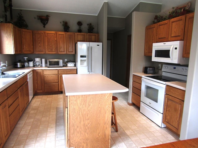 180 Bordson St, Appleton, MN 56208 - kitchen featuring white appliances, light flooring, a kitchen island, and a sink