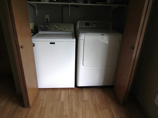 180 Bordson St, Appleton, MN 56208 - laundry area with washer and clothes dryer and wood finished floors