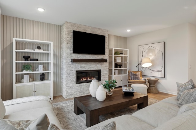 14625 105th Pl N, Maple Grove, MN 55369 - living room featuring wood finished floors, baseboards, a stone fireplace, and recessed lighting