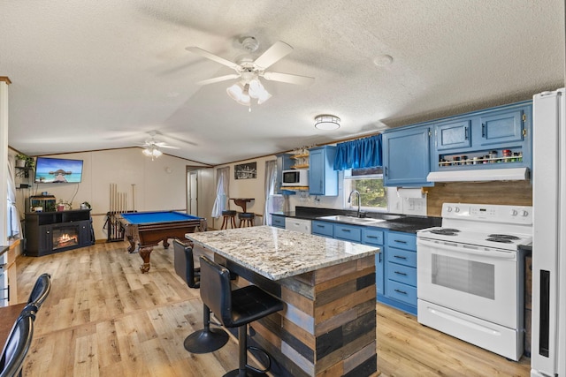 4799 Bridgewater Rd, Fair Haven Twp, MN 55382 - kitchen with white appliances, blue cabinets, light wood-type flooring, a textured ceiling, and under cabinet range hood