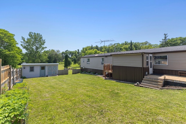 4799 Bridgewater Rd, Fair Haven Twp, MN 55382 - fenced backyard featuring a deck, an outbuilding, and view of scattered trees