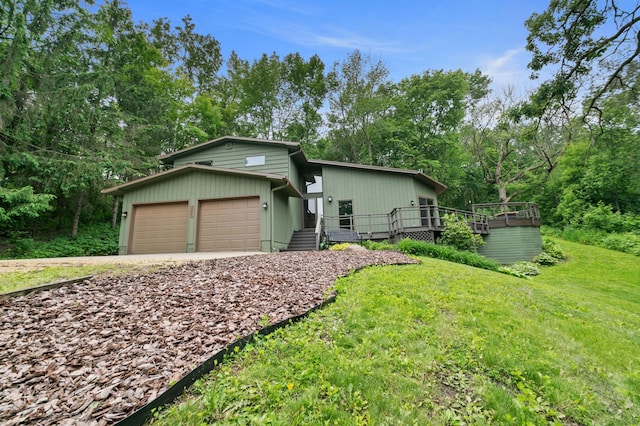 N7775 920th St, River Falls, WI 54022 - mid-century inspired home with a garage, a front yard, driveway, and a wooden deck