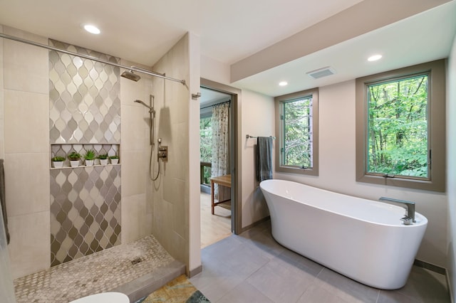 N7775 920th St, River Falls, WI 54022 - full bath with a freestanding bath, a walk in shower, recessed lighting, and tile patterned floors