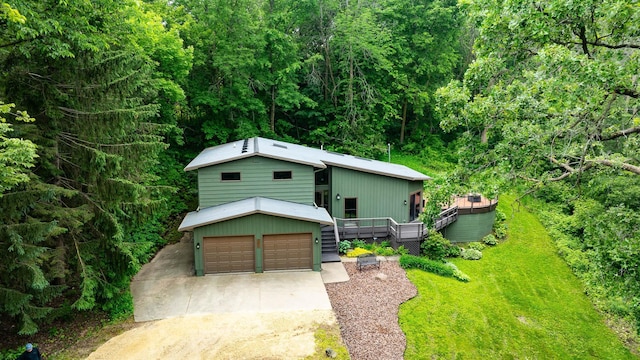 N7775 920th St, River Falls, WI 54022 - view of front facade with a deck, a view of trees, and driveway