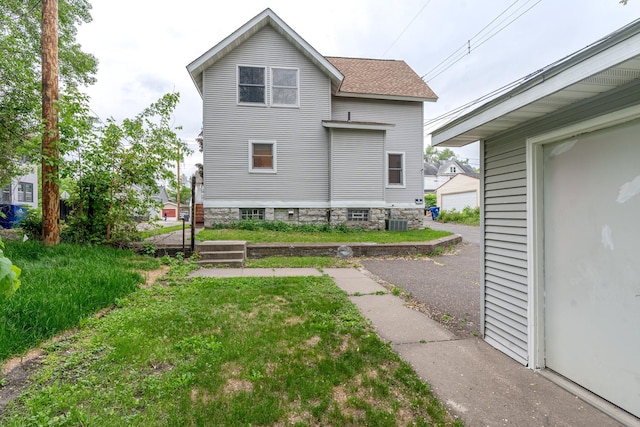 475 Minnehaha Ave E, Saint Paul, MN 55130 - back of property with central air condition unit and a shingled roof
