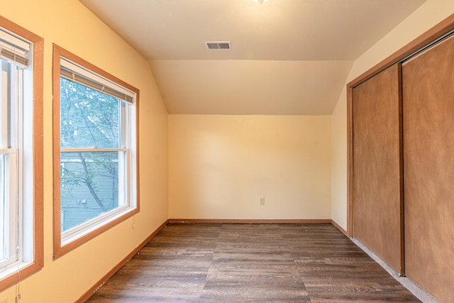 475 Minnehaha Ave E, Saint Paul, MN 55130 - unfurnished bedroom featuring vaulted ceiling, dark wood-type flooring, a closet, and baseboards