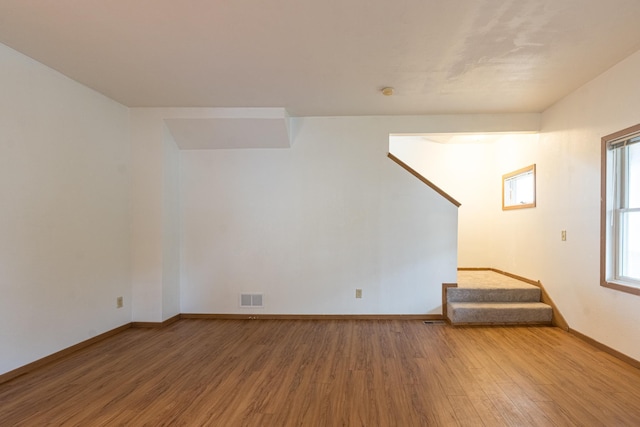 475 Minnehaha Ave E, Saint Paul, MN 55130 - unfurnished room featuring wood finished floors, baseboards, and stairway