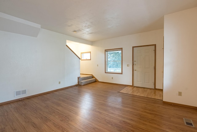 475 Minnehaha Ave E, Saint Paul, MN 55130 - empty room featuring wood finished floors, baseboards, and stairs