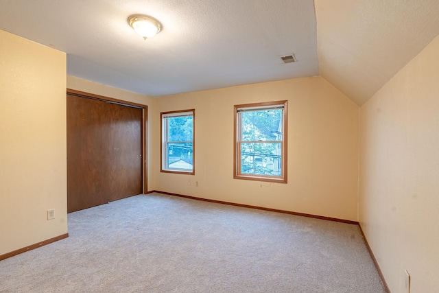 475 Minnehaha Ave E, Saint Paul, MN 55130 - unfurnished bedroom with carpet floors, a closet, lofted ceiling, and baseboards