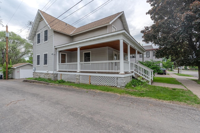 475 Minnehaha Ave E, Saint Paul, MN 55130 - farmhouse-style home with a porch, roof with shingles, and an outdoor structure