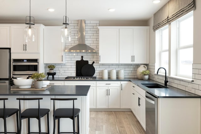 14705 105th Pl N, Maple Grove, MN 55369 - kitchen featuring stainless steel appliances, wall chimney exhaust hood, a sink, dark countertops, and recessed lighting