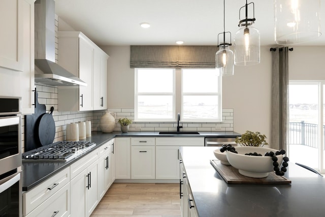 14705 105th Pl N, Maple Grove, MN 55369 - kitchen featuring wall chimney exhaust hood, a sink, dark countertops, light wood finished floors, and recessed lighting
