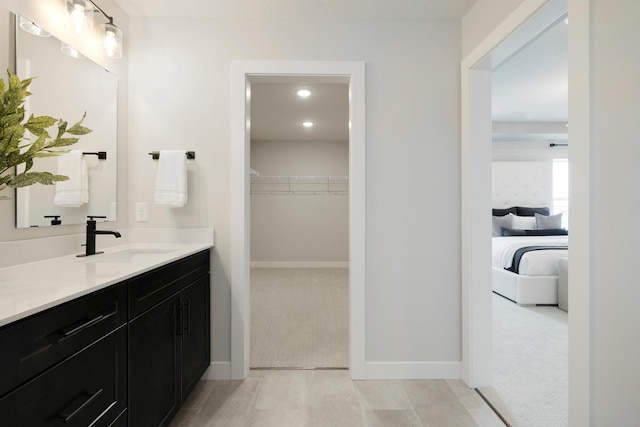 14705 105th Pl N, Maple Grove, MN 55369 - bathroom featuring vanity, a spacious closet, baseboards, and recessed lighting