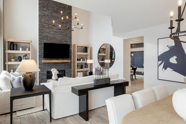 14705 105th Pl N, Maple Grove, MN 55369 - living room with a stone fireplace, light wood-style floors, and a chandelier