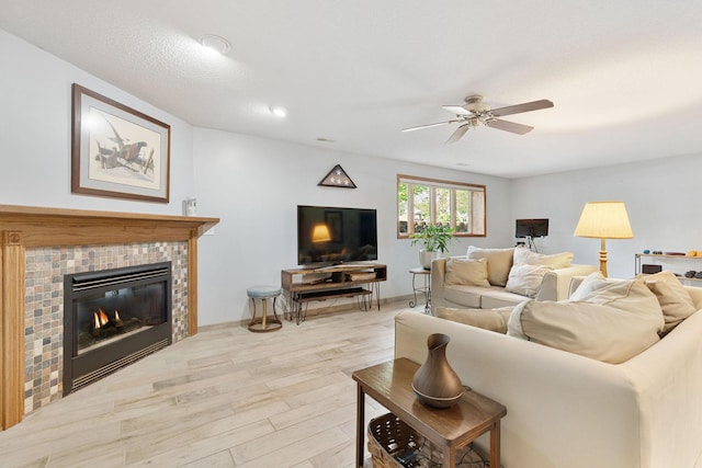 2800 9th Ave SW, Austin, MN 55912 - living area with wood finished floors, a ceiling fan, and a fireplace