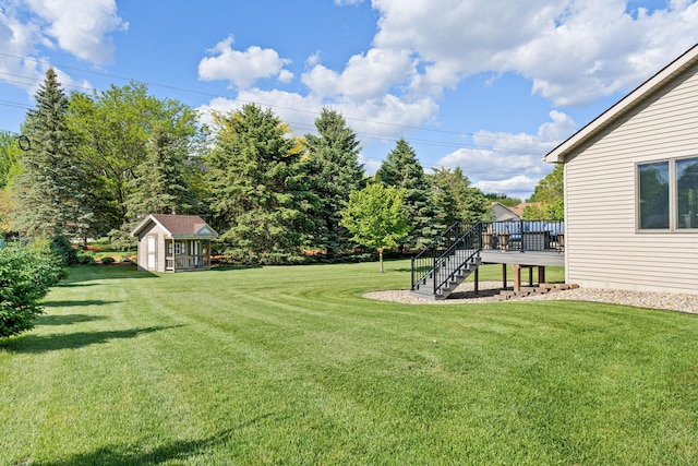 2800 9th Ave SW, Austin, MN 55912 - view of grassy yard featuring stairway, a wooden deck, and an outdoor structure