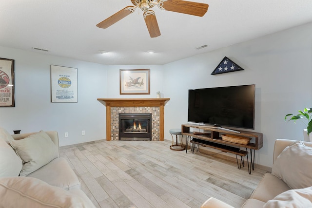 2800 9th Ave SW, Austin, MN 55912 - living area featuring wood finished floors, ceiling fan, a tile fireplace, and baseboards