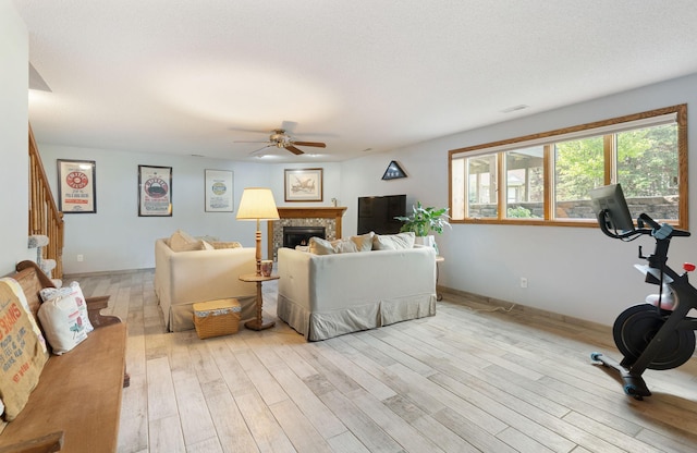 2800 9th Ave SW, Austin, MN 55912 - living area with a ceiling fan, light wood finished floors, stairway, and a fireplace