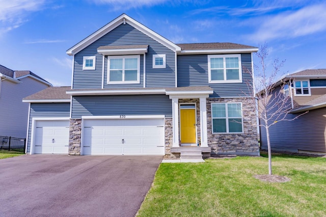 830 Foxglove Ter, Waconia, MN 55387 - view of front of home with stone siding, driveway, roof with shingles, and an attached garage
